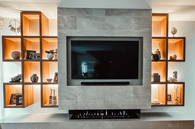 Hand laid large format wall tiles in grey colour in rumpus room surrounding a televisin