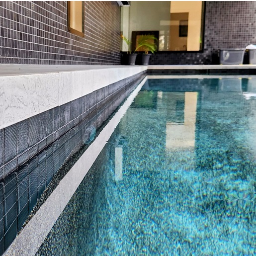 Close up view of swimming pool tiling job completed by Dejan